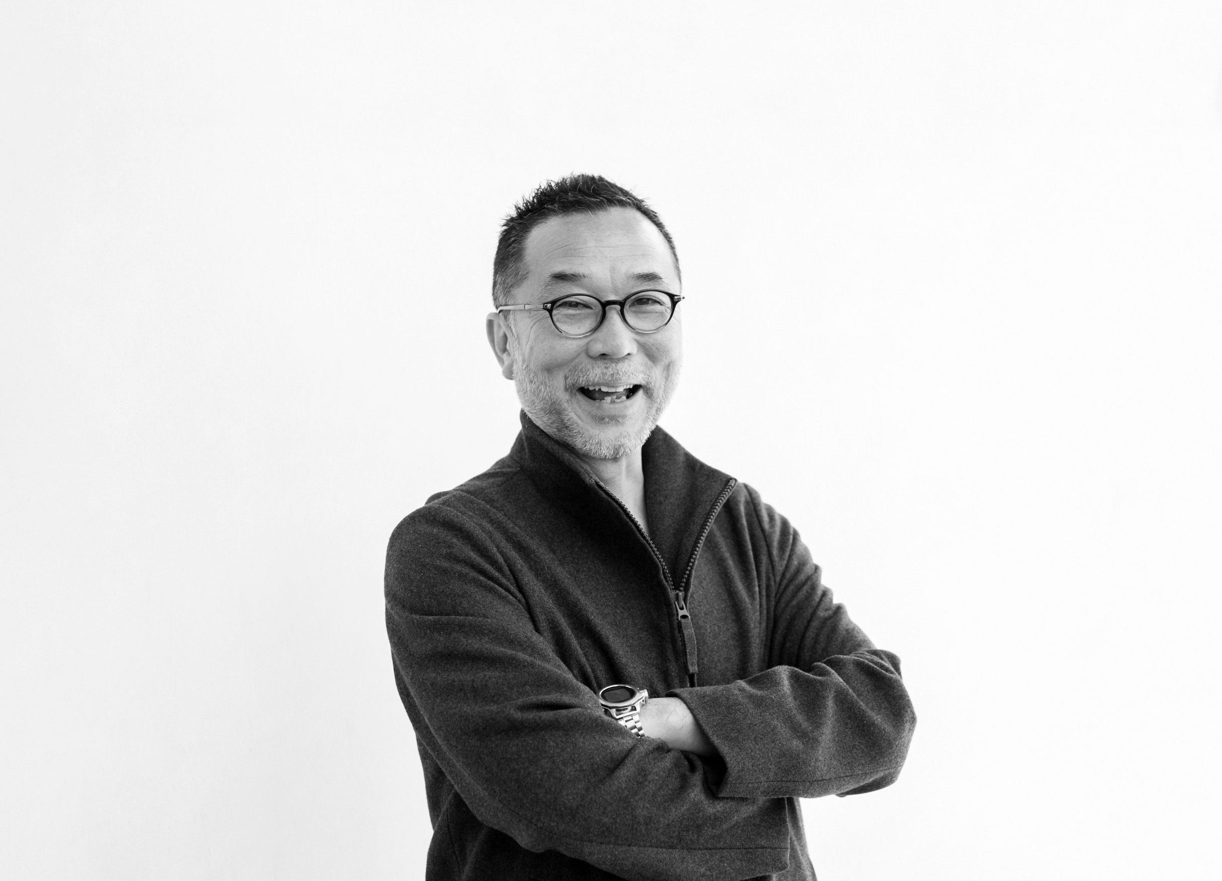 The man standing in front of a white background.